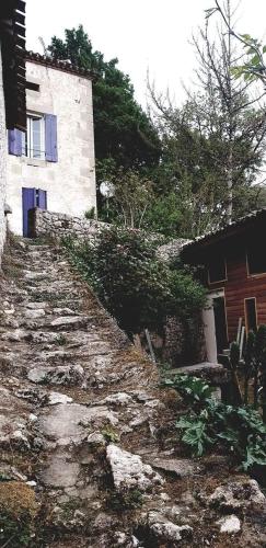 an old stone path in front of a building at Les Gîtes du Hameau avec piscine in Castelnau-sur-Gupie