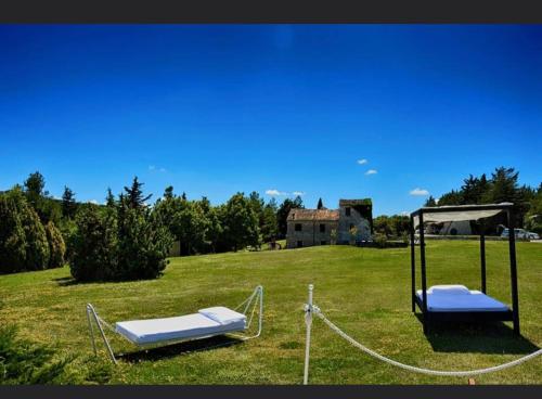 two beds in a field with a gazebo at Riserva Privata San Settimio in Arcevia