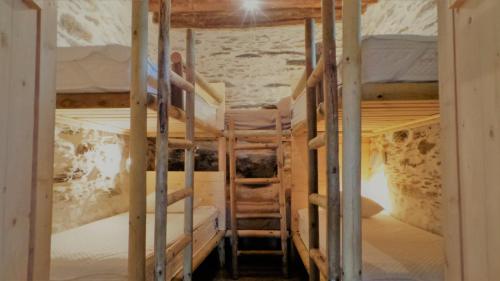 a couple of bunk beds in a room at Konaki Hikers Lodge by Andros Routes in Andros