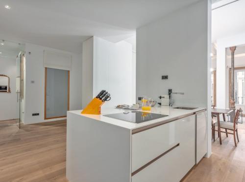 a kitchen with white counters and a white counter top at City Center modern apartment for 4 SANTA TERESA II in Madrid