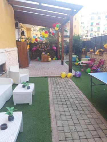 a patio with a table and chairs and balloons at Family Room in Portici