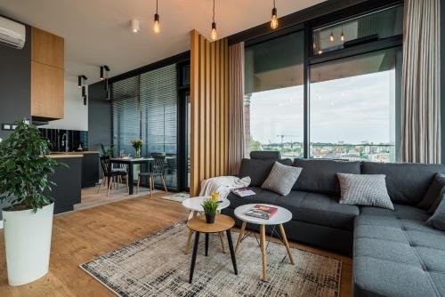 a living room with a couch and a table at Q18 ApartHotel in Bydgoszcz