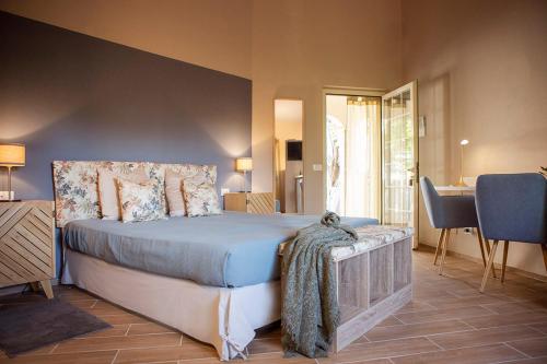 a bedroom with a bed and a table and chairs at RTA Costa Etrusca in San Vincenzo
