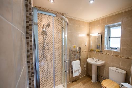 a bathroom with a shower and a sink at The Coach and Horses in Oxford