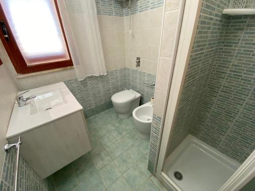 a bathroom with a toilet and a sink and a shower at VILLA CHANTAL in Lampedusa