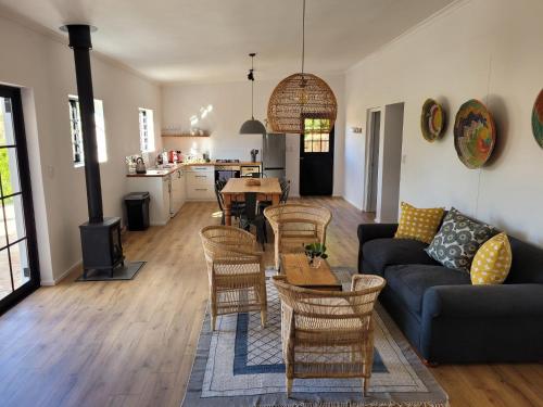 a living room with a couch and chairs and a table at Beaumont Family Wines in Botrivier