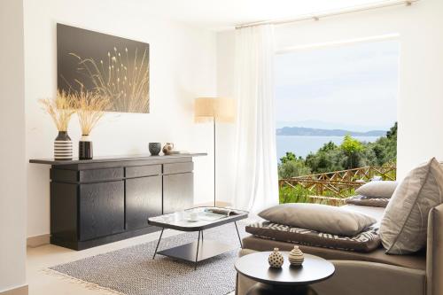 a living room with a couch and a table at Eagles Villas - Small Luxury Hotels of The World in Ouranoupoli