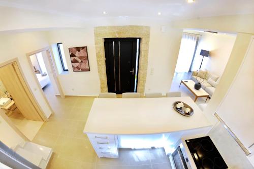 a living room with a white table and chairs at Stone Crafted Luxury Villas in Nikiana
