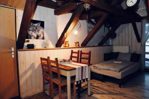 a dining room with a table and a dog on the wall at Chata u Kostela in Dolni Misecky