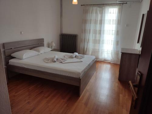 a bedroom with a bed with two towels on it at THEA COURT Clio & Erato Apartments in Paleo Tsifliki
