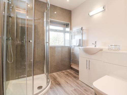 a bathroom with a shower and a sink at Batty Hole Farm in Burnley