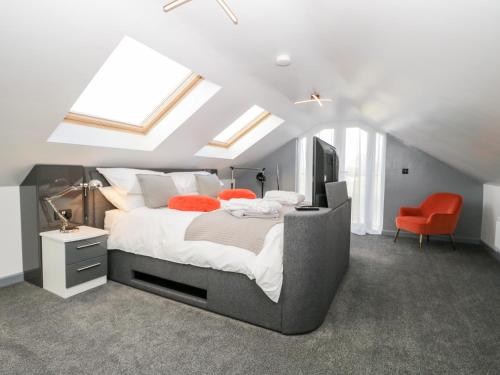 a bedroom with a large bed in a attic at The Annex in Ulverston