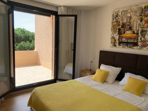 a bedroom with a large bed and a large window at Mon Ecrin sur la marina du Golfe de St Tropez in Cogolin