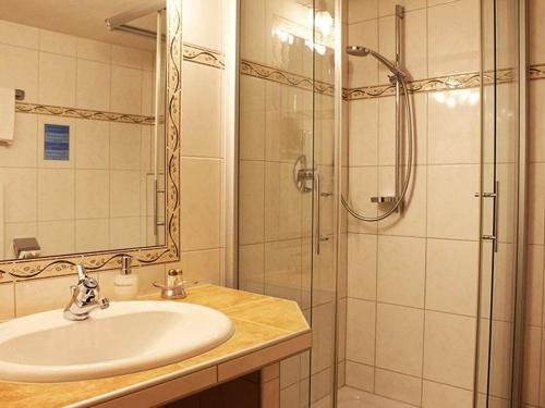 a bathroom with a sink and a shower at Hotel Edelweiẞ garni in Berwang