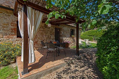 a patio with a table and chairs under awning at Agriturismo Casavaiano in Gambassi Terme