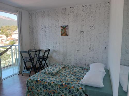 Ένα ή περισσότερα κρεβάτια σε δωμάτιο στο Hospedagem Sol Nascente