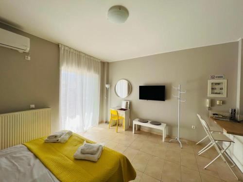 ein Schlafzimmer mit einem Bett mit einer gelben Decke darauf in der Unterkunft Sunlight studio in Athen