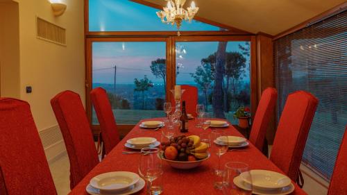 a dining room table with a bowl of fruit on it at Villa California 6, Emma Villas in Saludecio