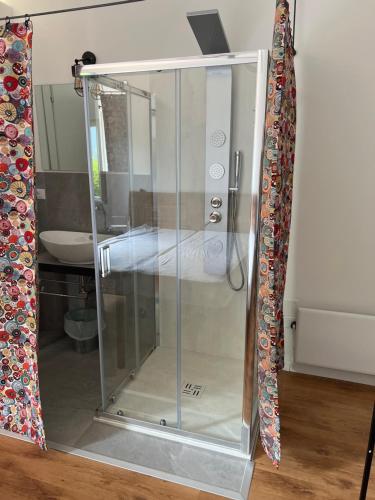 a glass shower stall in a room with a sink at Albergo Wellness Da Febo in Tramonti di Sotto