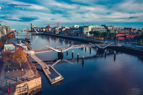 a view of a river with a bridge and a city at The Camden Street Hotel in Dublin