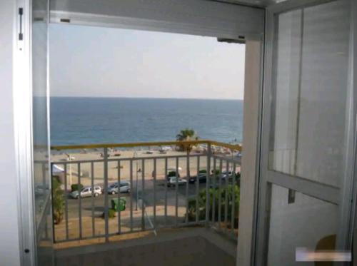 a room with a view of the ocean from a balcony at Appartamento con vista sul mare in Marina di Gioiosa Ionica