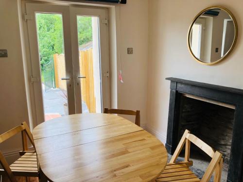 a wooden table and chairs in a room with a mirror at Mount Cottage in Newcastle Emlyn