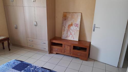 a room with a cabinet and a painting on the wall at Adarissa House in Rabat