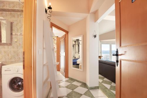 a bathroom with a washer and dryer at Apartments Gordana in Lokva Rogoznica