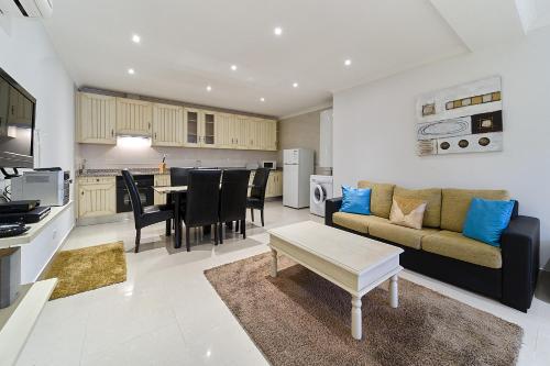 a living room and kitchen with a couch and a table at 812 Quinta Marina in Lagos
