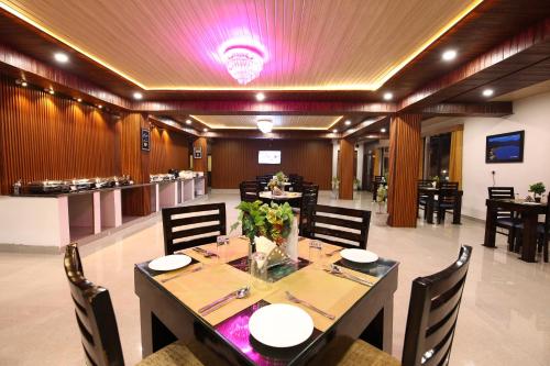 a dining room with a long table and chairs at Amritara The Avadh in Badrīnāth