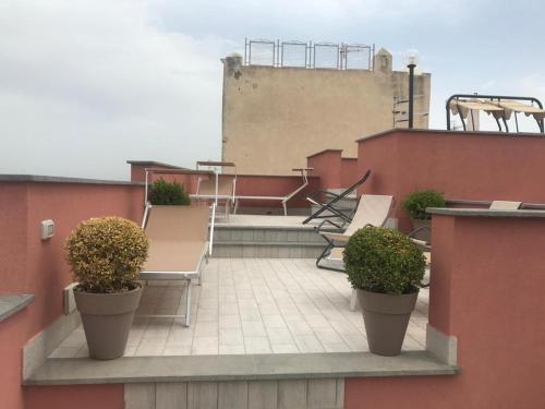 a balcony with benches and plants on a building at B&B La Lingua in Procida