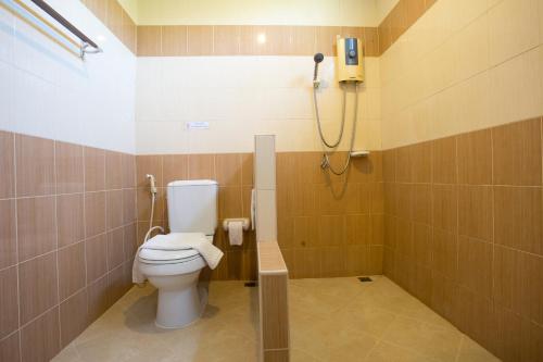 a bathroom with a toilet and a shower at Phusuay Park View Hotel in Chaiyaphum
