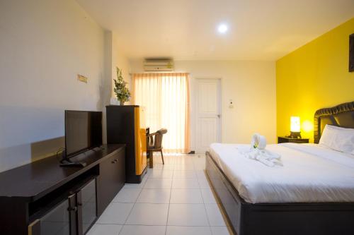 a hotel room with a bed and a television at Phusuay Park View Hotel in Chaiyaphum
