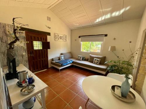 a living room with a couch and a table at La Fuente Oase B&B in Coín