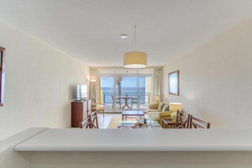 a living room with a view of the ocean at Tranquil Beachside Stay - Atlantic Gardens Beach in Funchal
