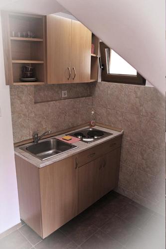 a small kitchen with a sink and a counter at Vila Mila in Petrovac na Moru