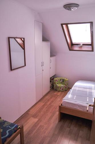 a bedroom with a bed and a skylight at Vila Mila in Petrovac na Moru