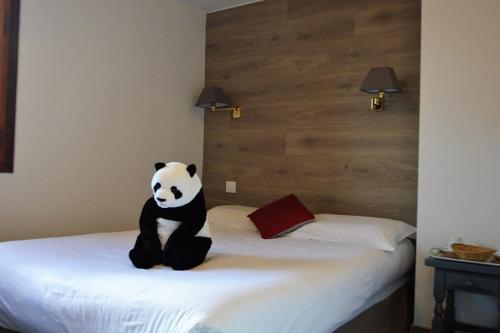 a teddy bear sitting on top of a bed at Hotel Panda in Pas de la Casa