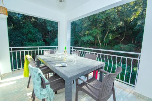 a dining table and chairs on a balcony at Casa Playa by Sonne Villas in Ferreries