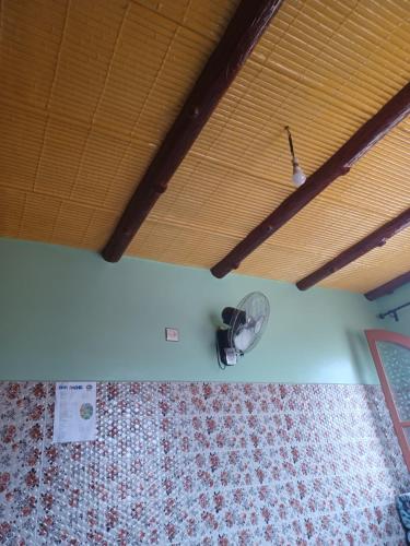 a room with a fan on the wall and a ceiling at Dar rachid ouzoud in Azilal