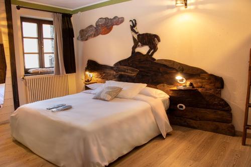 a bedroom with a bed and a statue of a giraffe at Maison Cly in Chamois