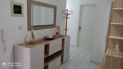 a bathroom with a sink and a mirror on a wall at Elea House in Keramoti