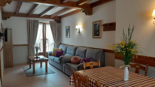 a living room with a couch and a table at Apartamentos El Haya in Cosgaya