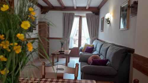 a living room with a couch and a table at Apartamentos El Haya in Cosgaya
