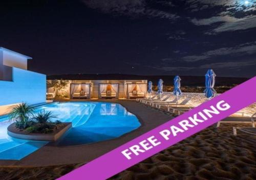 a swimming pool at night with the words free parking at Airotel Alexandros in Athens