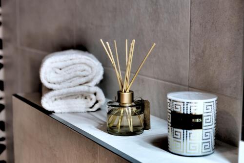 a shelf in a bathroom with towels and a candle at Villa Gunga in Mostar
