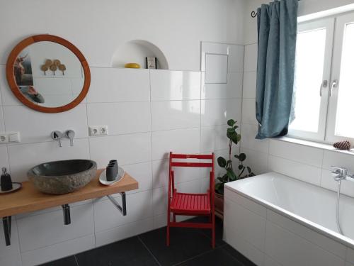 a bathroom with a tub and a sink and a mirror at Ferienwohnung Biobauernhof Peter Anderl Hof in Pfreimd