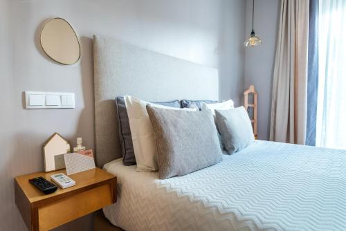 a bedroom with a bed with a mirror and a table at Casas da Formosa - Downtown Alegria in Tavira