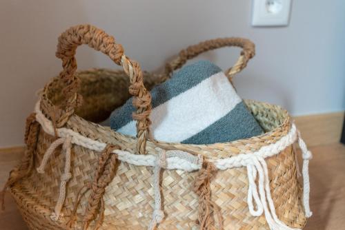 a basket filled with towels on a table at Casas da Formosa - Downtown Alegria in Tavira