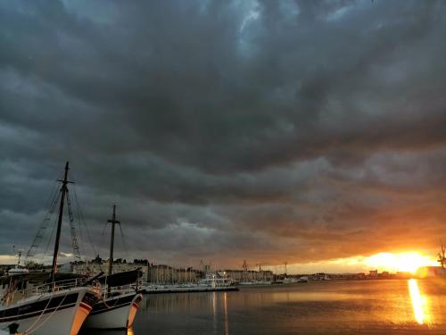 a boat docked in a harbor with a sunset at Pula Center Studio Apartments in Pula